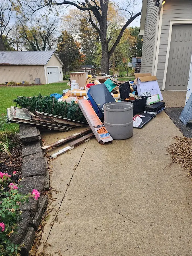 Dumpster being loaded with debris for 3 Yard Dumpster Rental in Country Homes